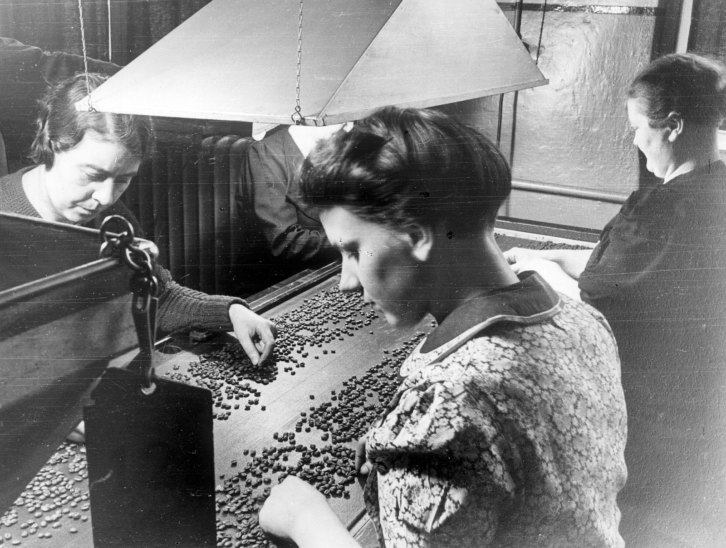 Arbeiterinnen beim auslesen von Kaffebohnen in einer Kaffeerösterei